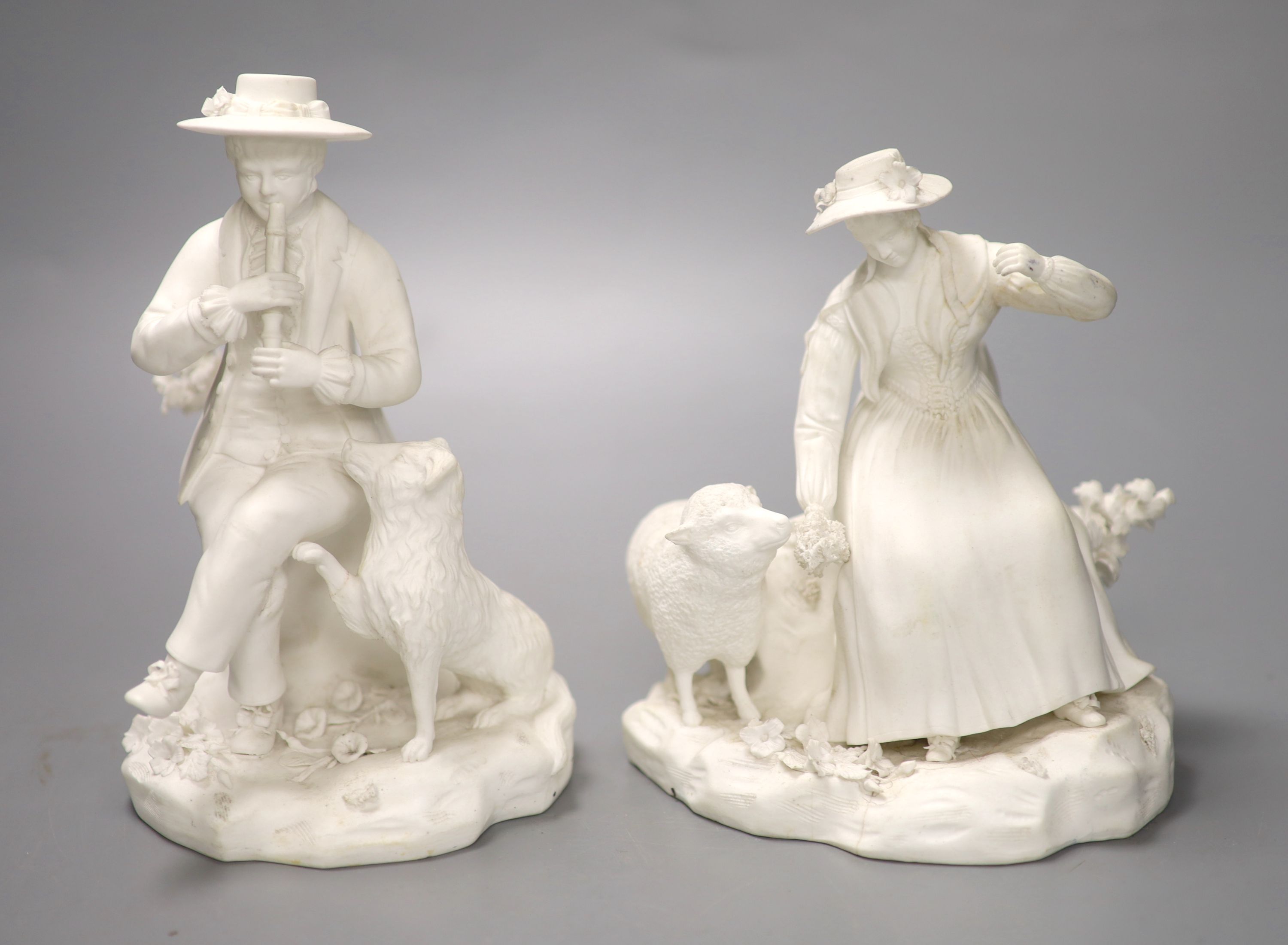 A pair of Rockingham biscuit figures of a boy with a dog and a girl with a sheep, tallest 18cm